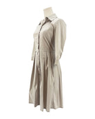 Beige long sleeve dress on a mannequin against a white background