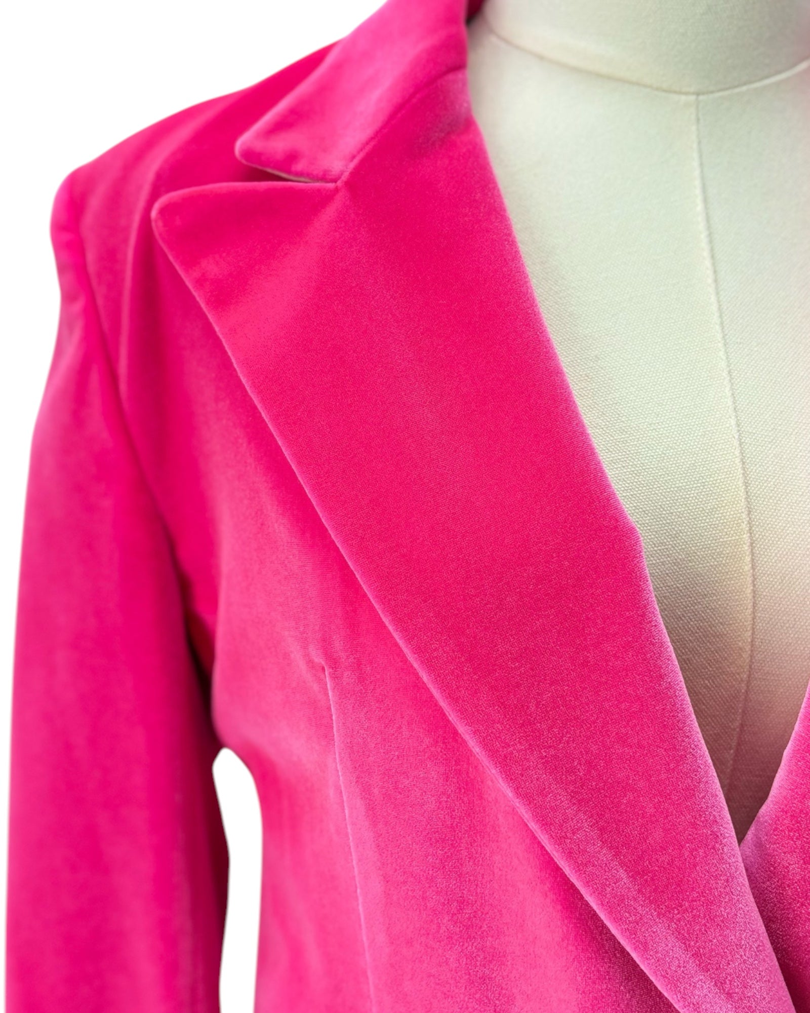 Close-up of a bright pink velvet garment on a mannequin.