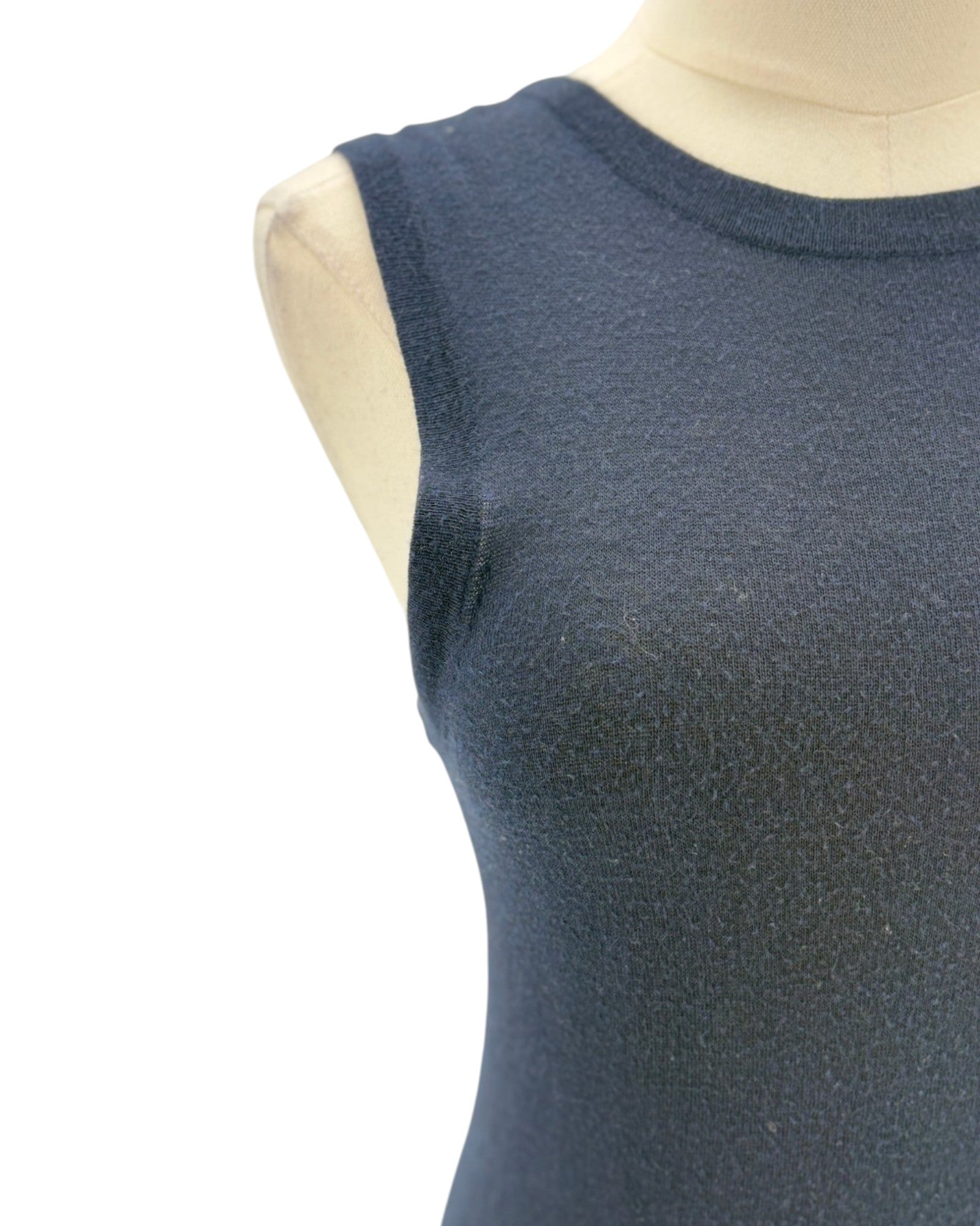 Navy blue sleeveless top on a mannequin against a white background