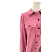 Pink shirt on a mannequin against a white background