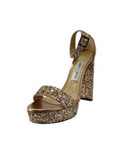 Gold glitter high heel shoe on a white background