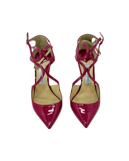 A pair of pointed-toe high heels in glossy patent burgundy with criss-cross ankle straps and a beige insole, shown against a plain white background.