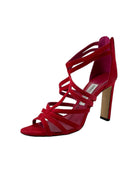 Red high-heeled sandal with strappy design on a white background