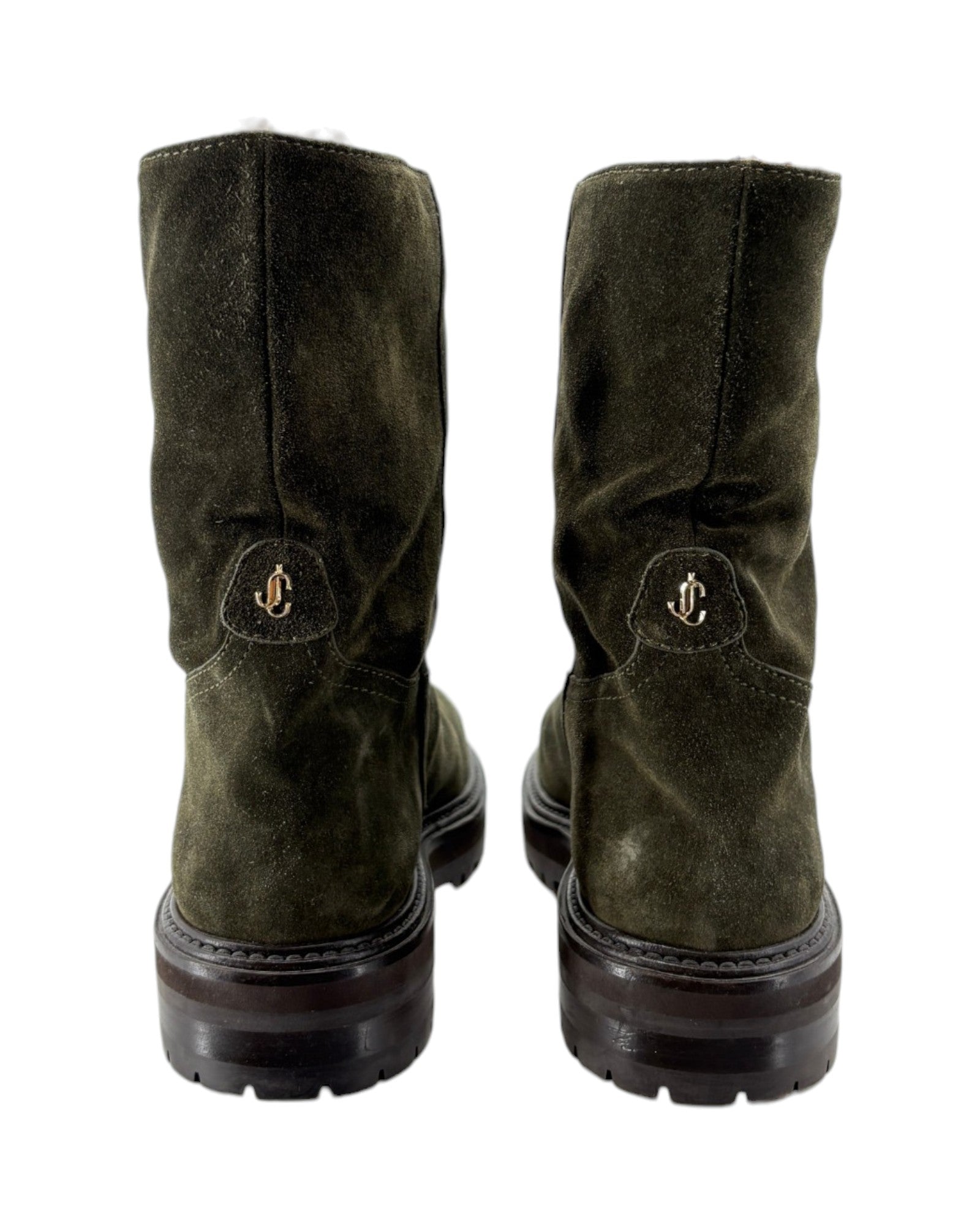 Pair of green suede boots with a brand logo on a white background