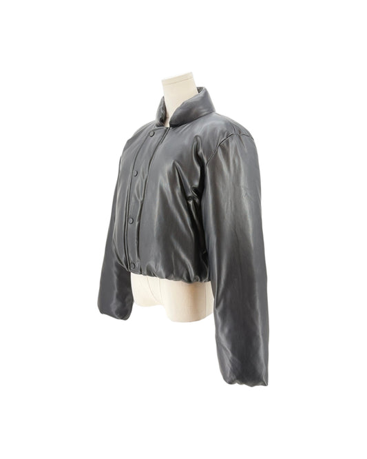 A cropped black leather jacket with a high collar and button front, displayed on a cream-colored mannequin torso against a plain white background.