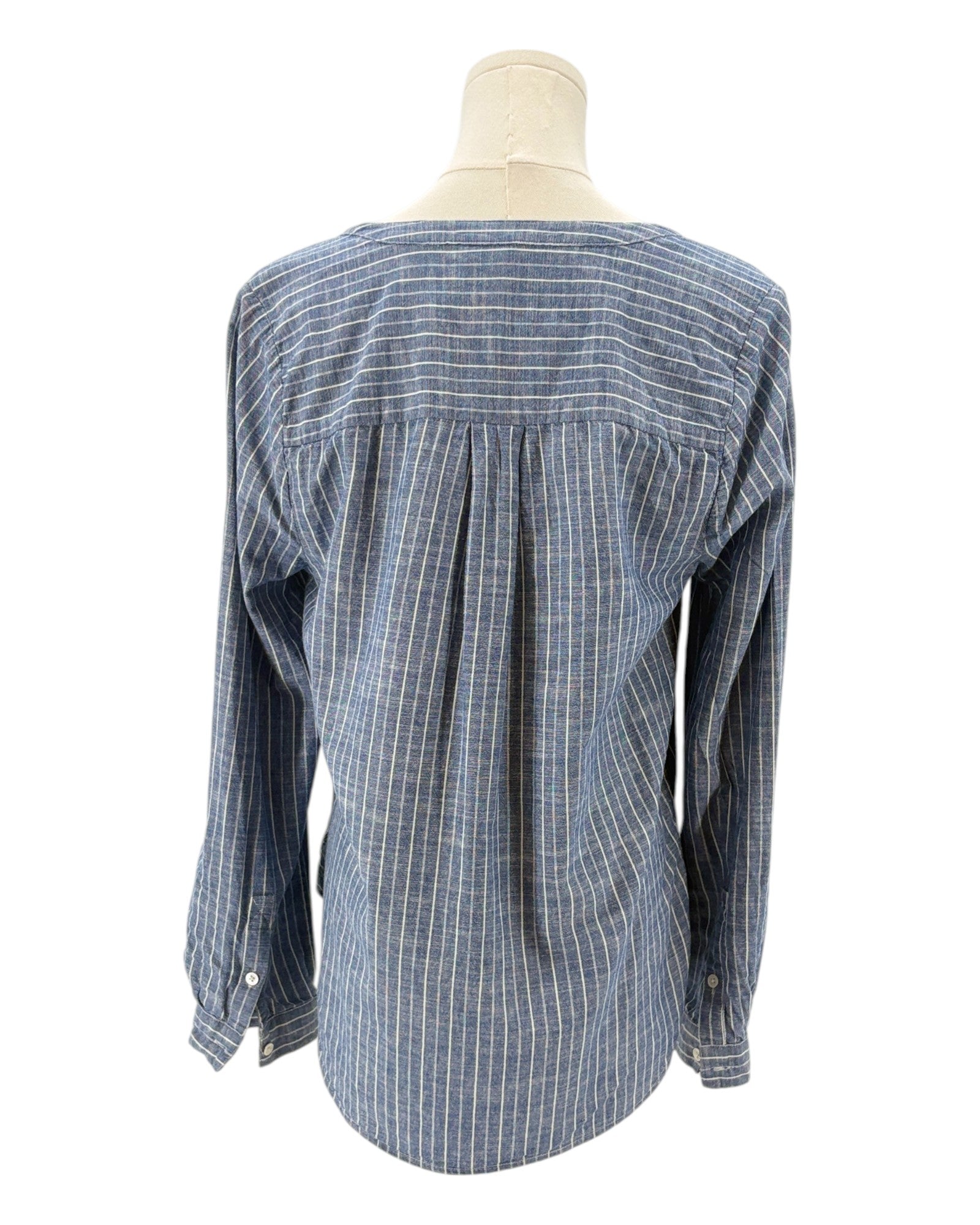 Blue and white striped shirt on a mannequin against a white background
