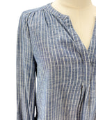Blue and white striped shirt on a mannequin against a white background