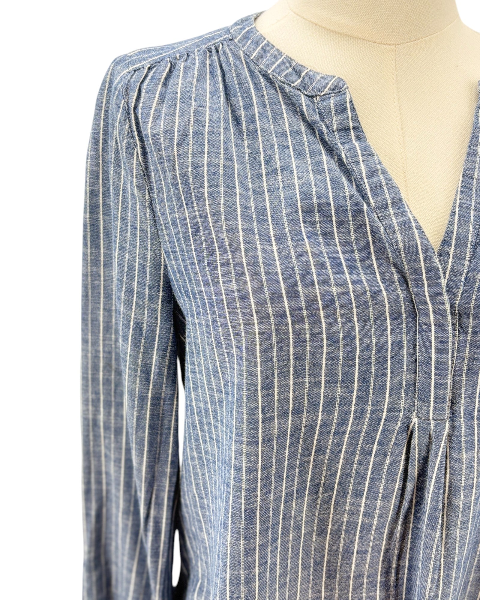 Blue and white striped shirt on a mannequin against a white background