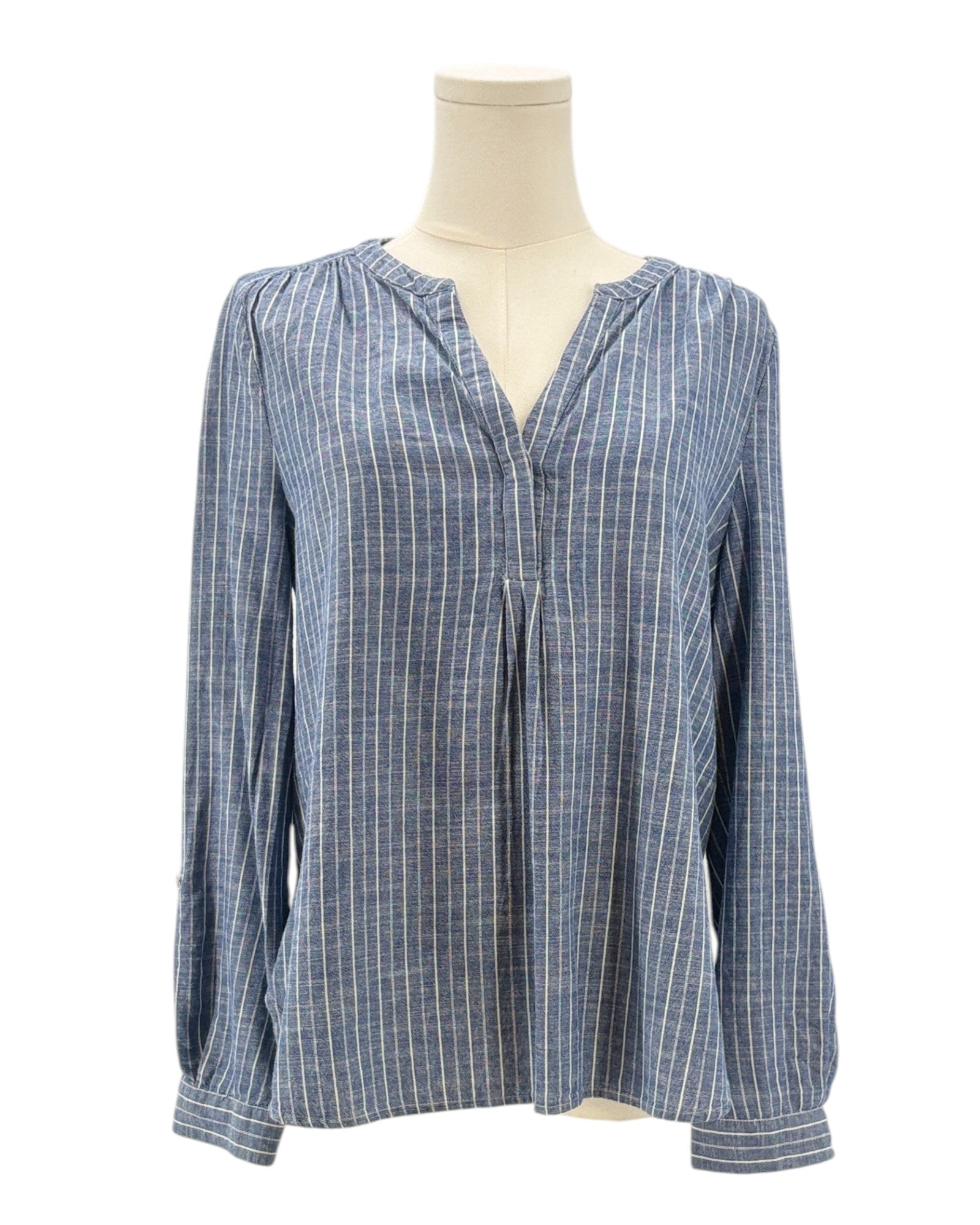 Blue and white striped blouse on a mannequin against a white background