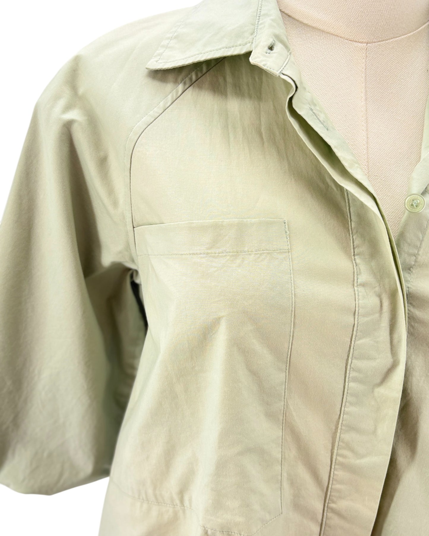 Light green dress on a mannequin against a white background