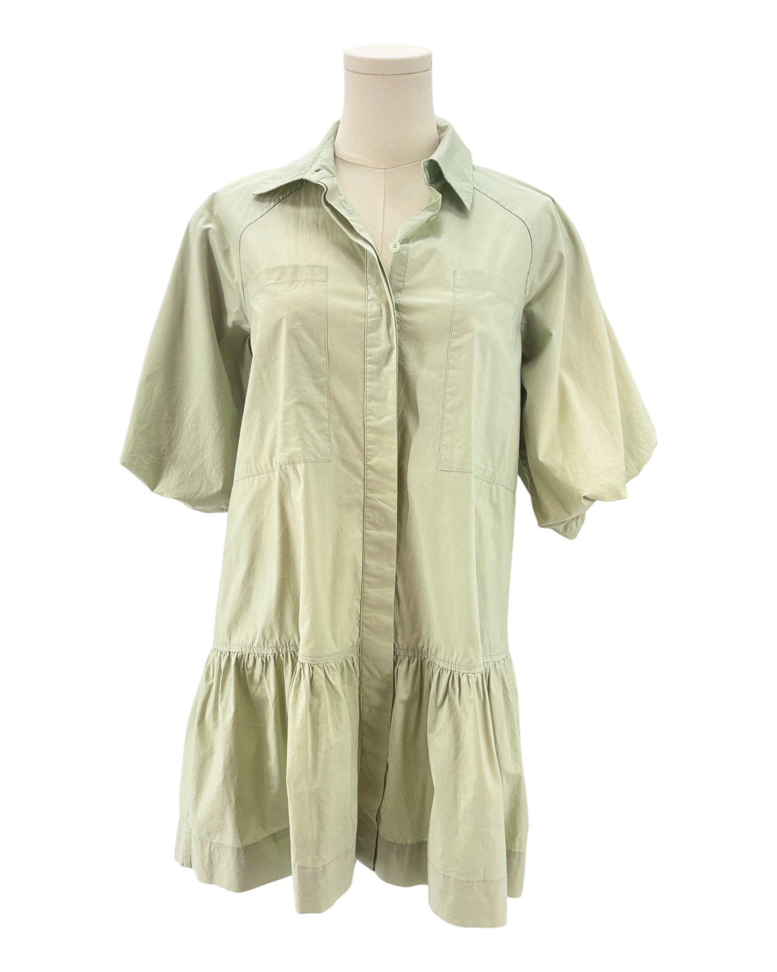 Light green dress on a mannequin against a white background
