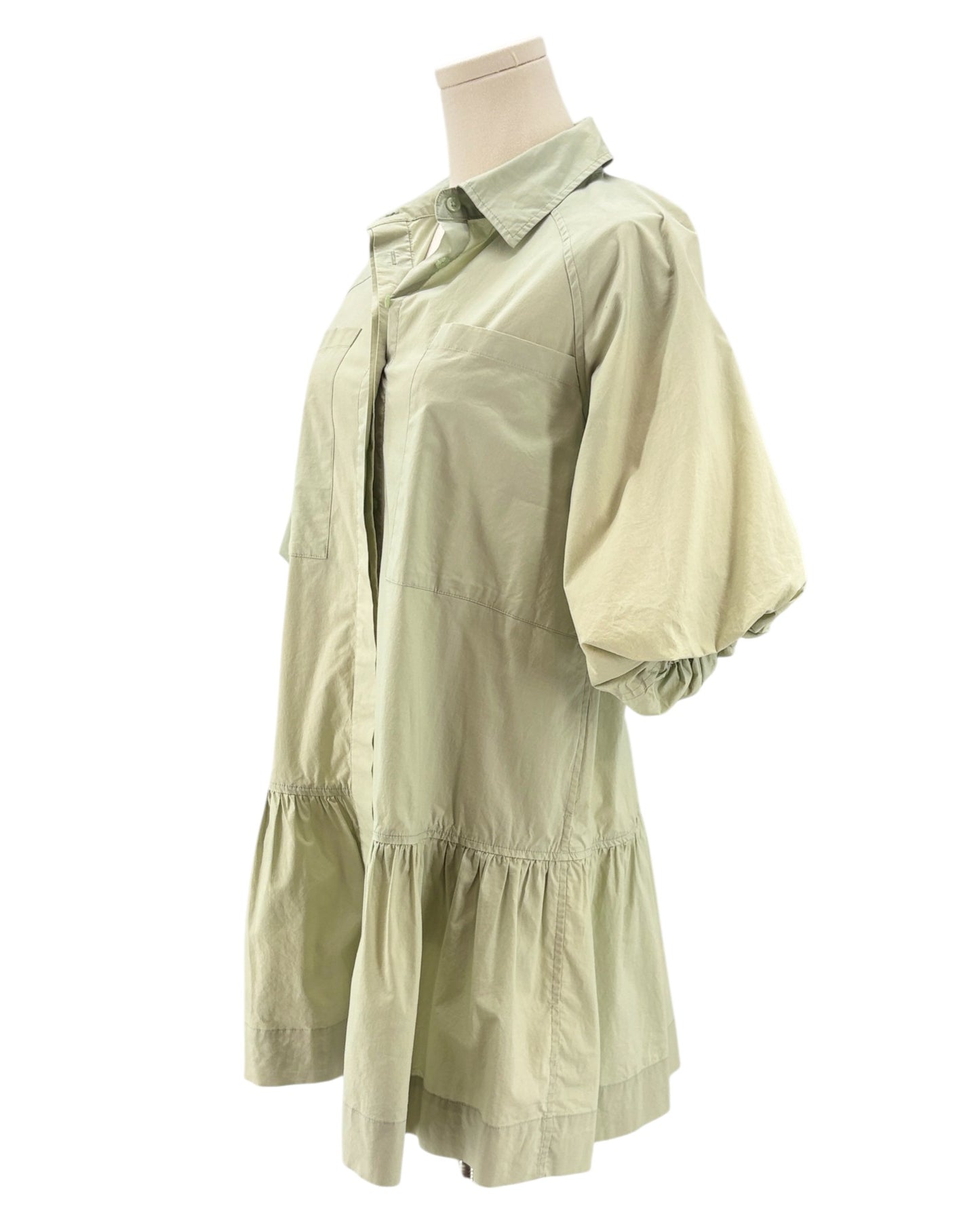Light green dress on a mannequin against a white background