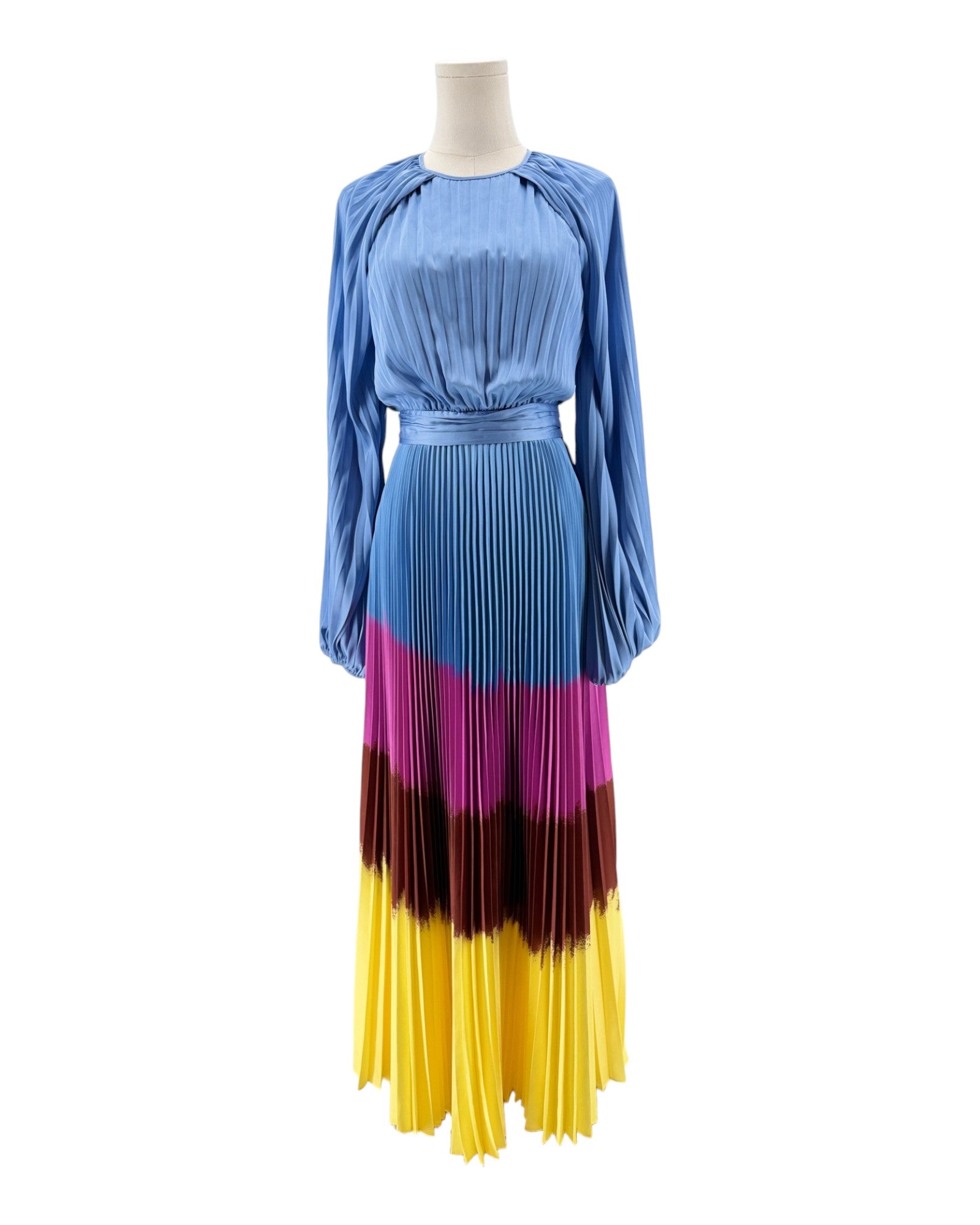 Mannequin wearing a dress with a blue top and colorful pleated skirt on a white background