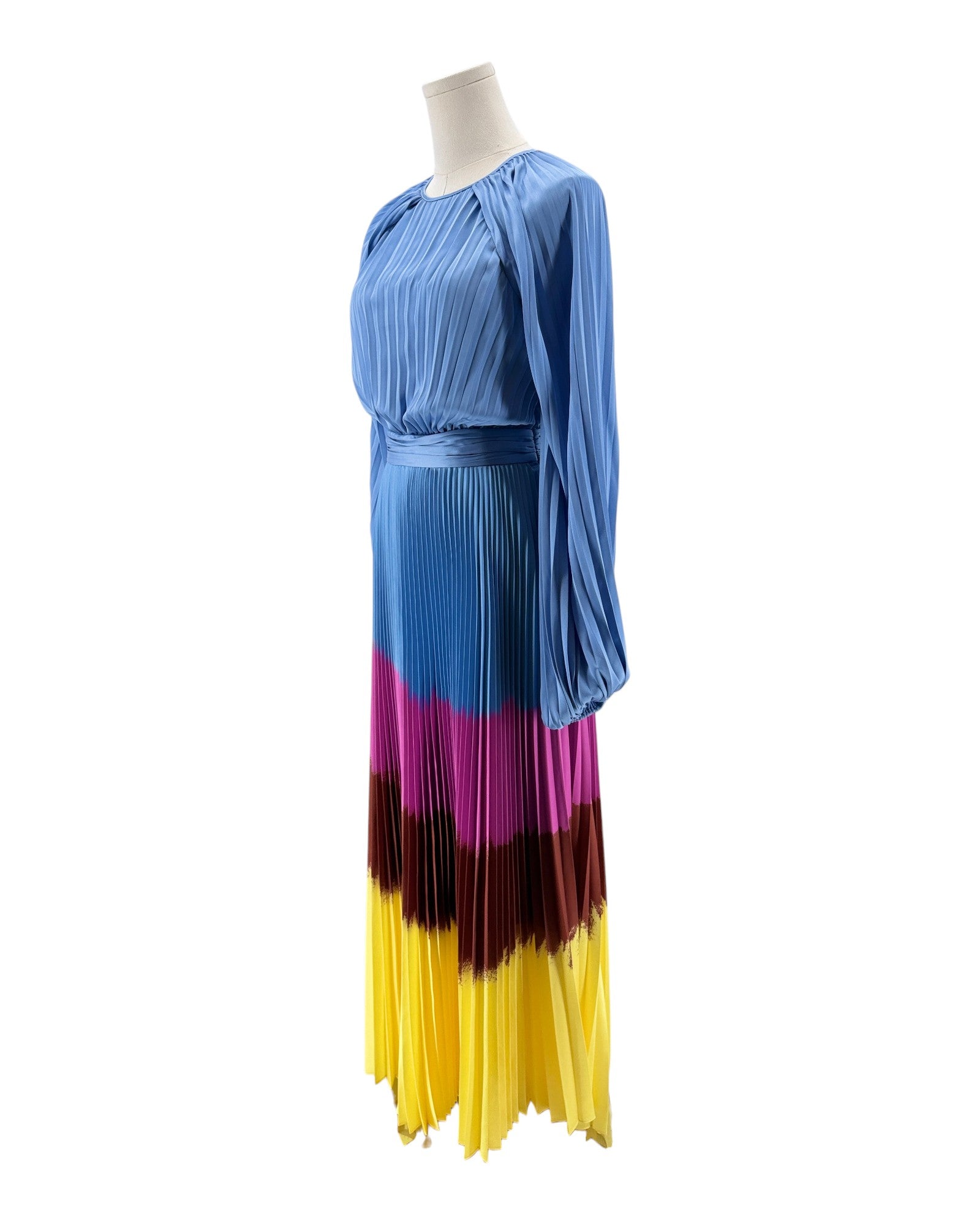 Mannequin wearing a blue, pink, and yellow pleated dress on a white background