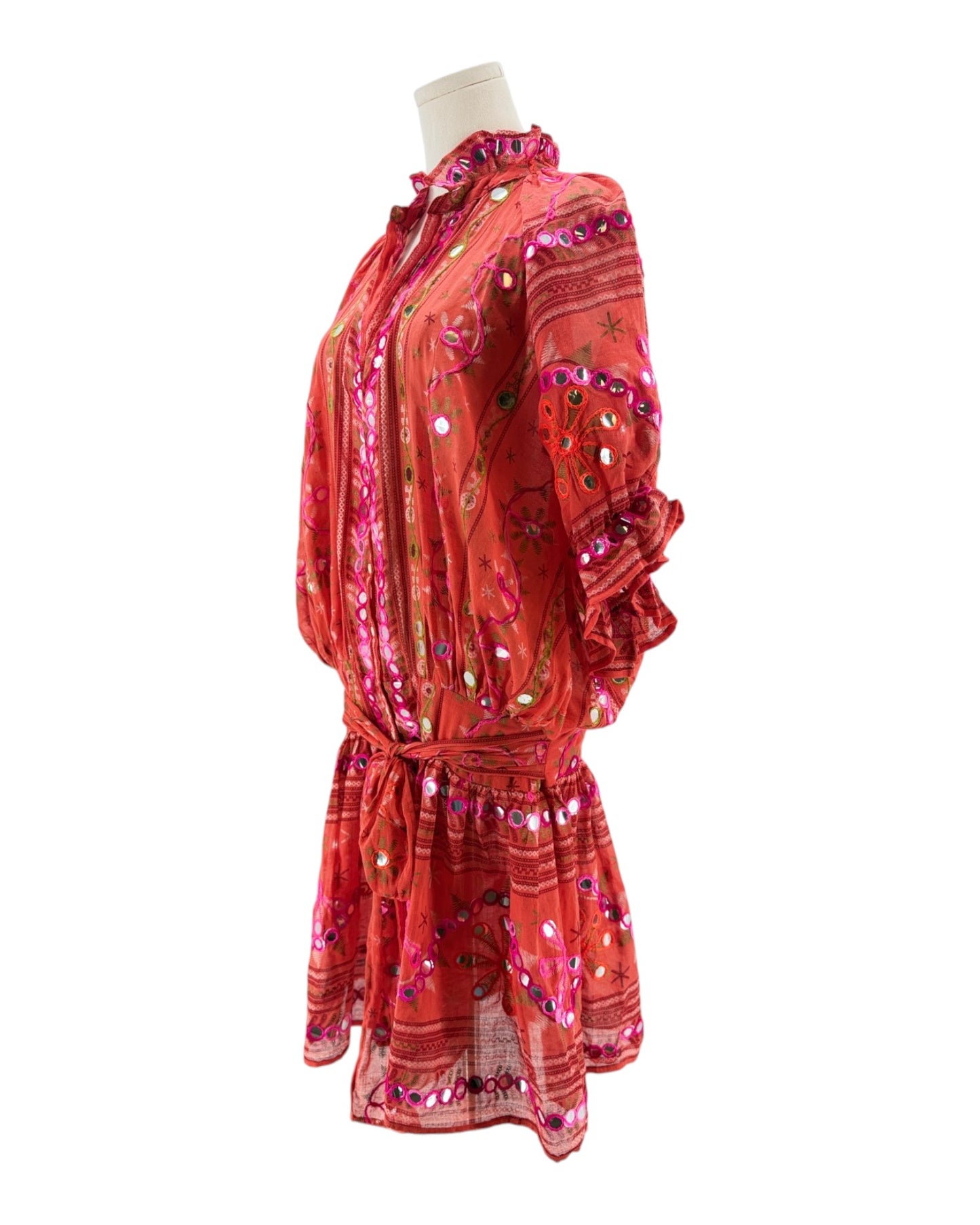 Red dress with floral patterns on a mannequin against a white background