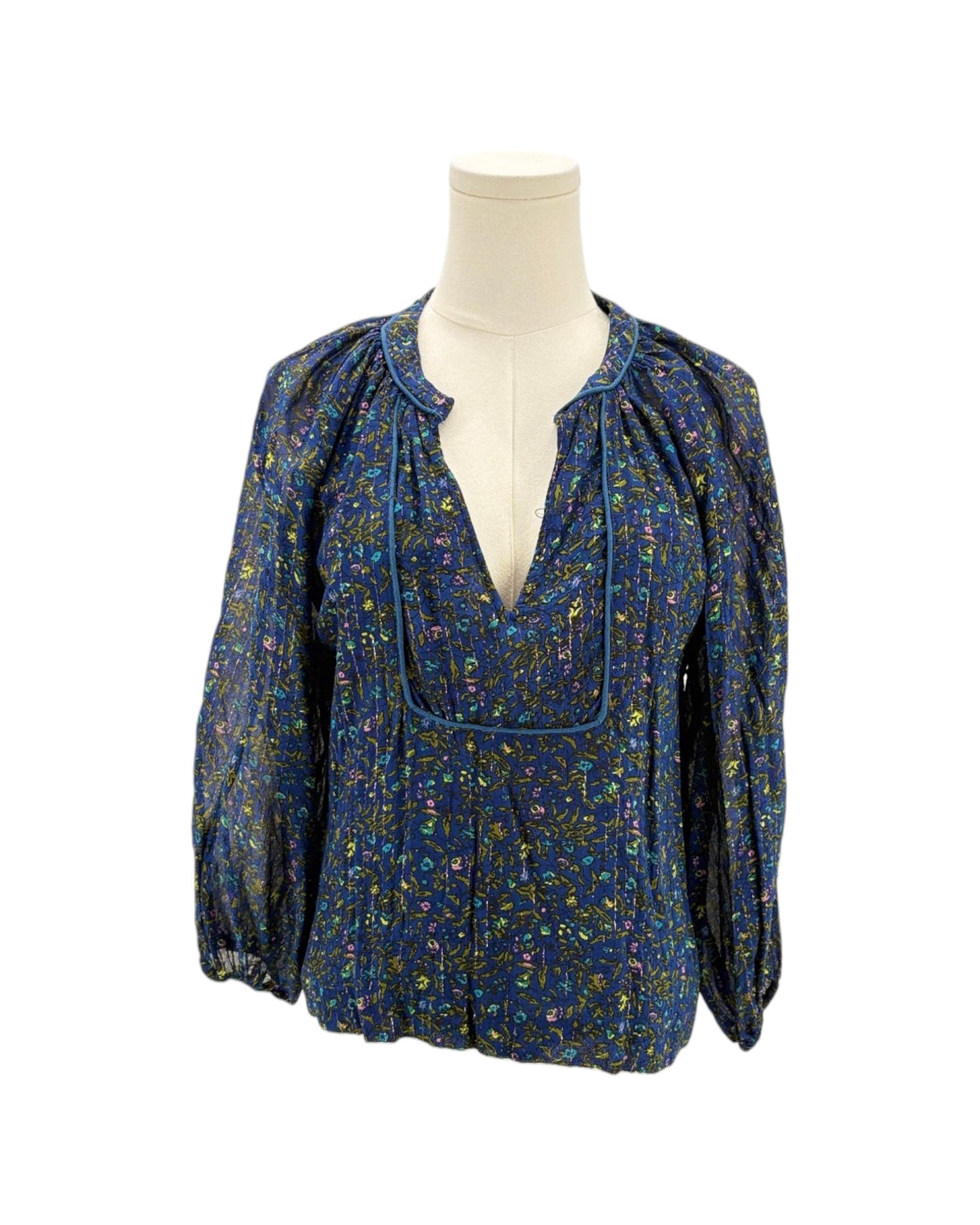 Blue floral blouse on a mannequin against a white background