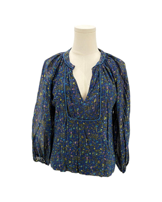 Blue floral blouse on a mannequin against a white background