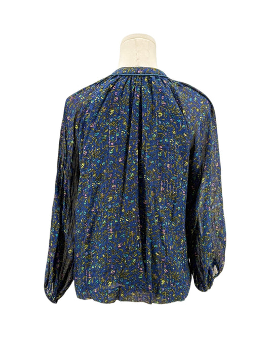 Blue patterned blouse on a mannequin against a white background