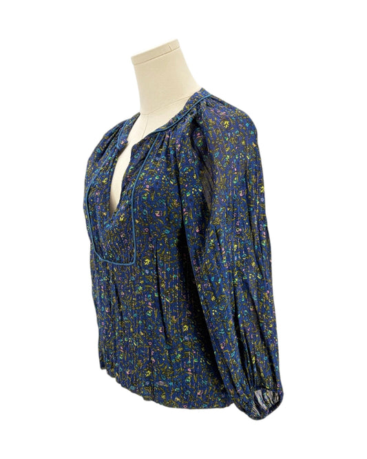 Blue floral blouse on a mannequin against a white background