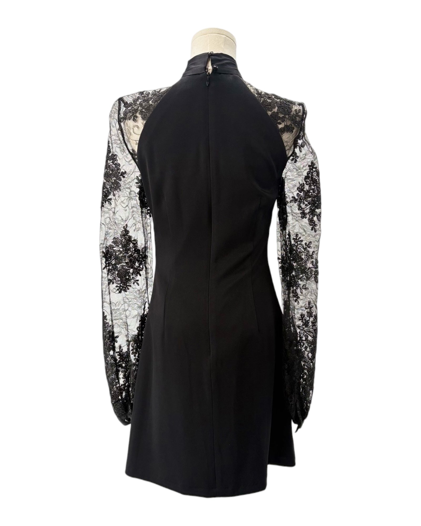 Black dress with floral lace sleeves on a mannequin against a white background
