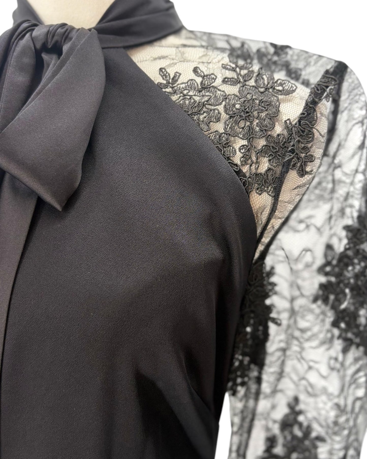 Black lace dress with a bow detail on a mannequin