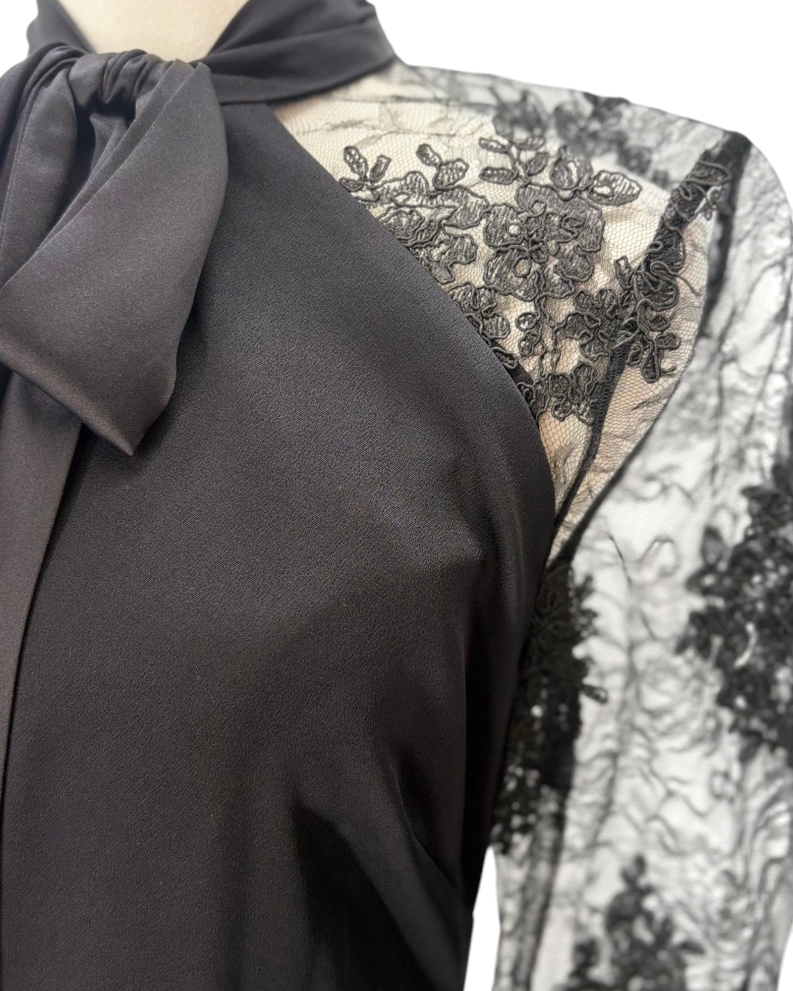 Black lace dress with a bow detail on a mannequin