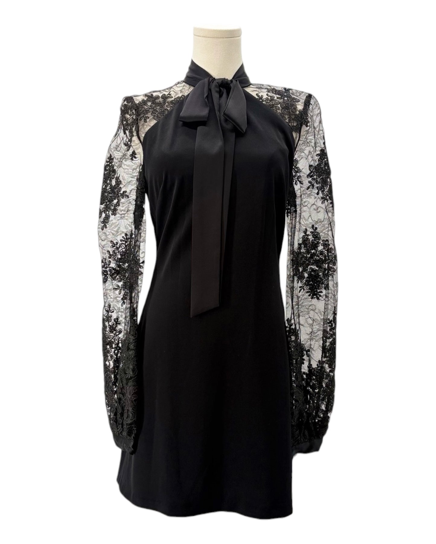 Black dress with floral lace sleeves on a mannequin against a white background