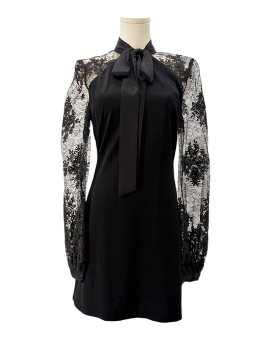 Black dress with floral lace sleeves on a mannequin against a white background