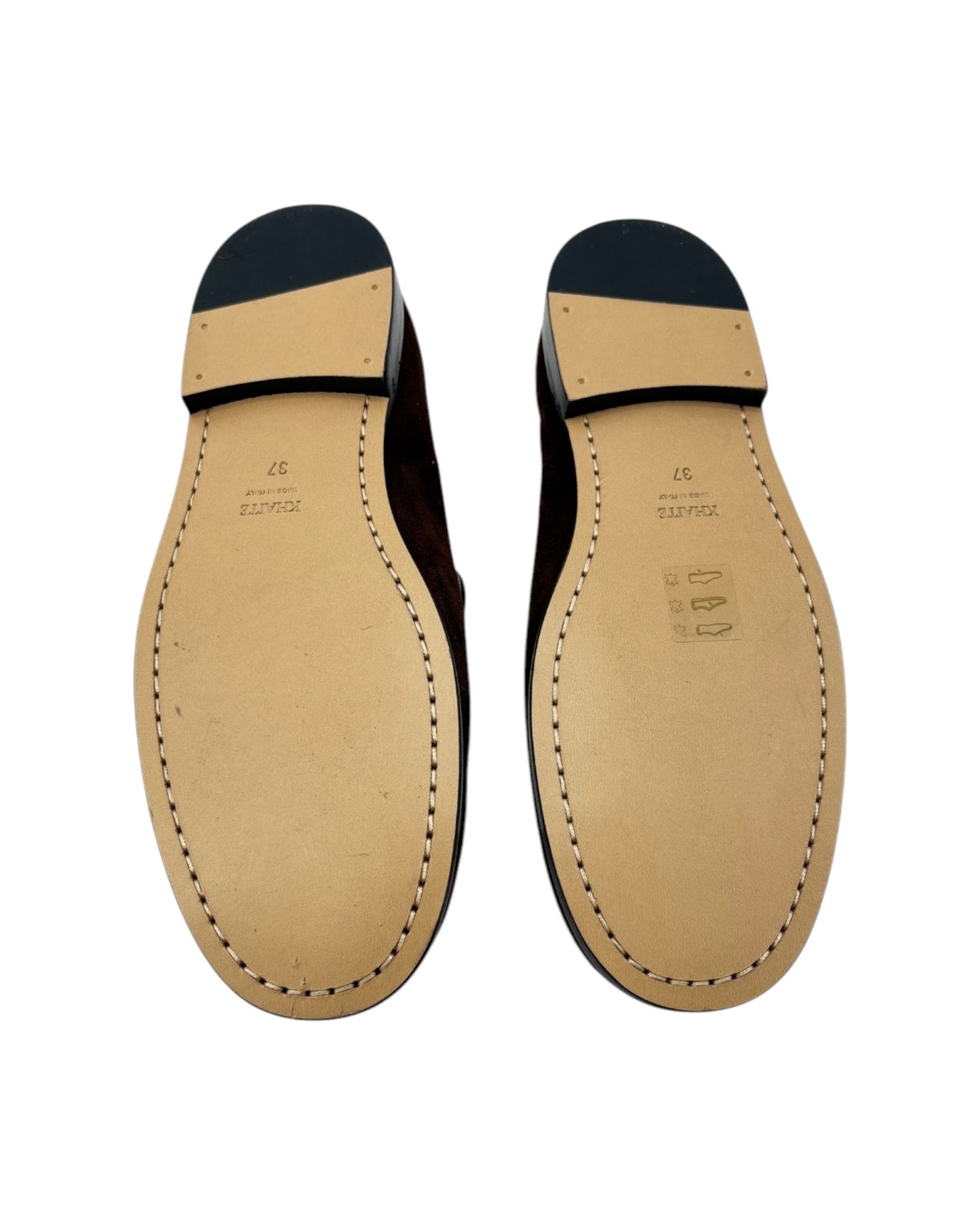 Pair of leather shoe soles on a white background