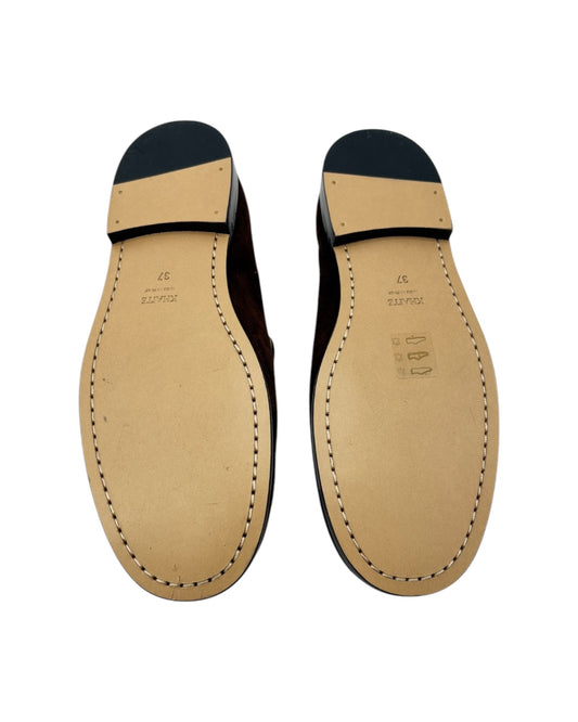 Pair of leather shoe soles on a white background