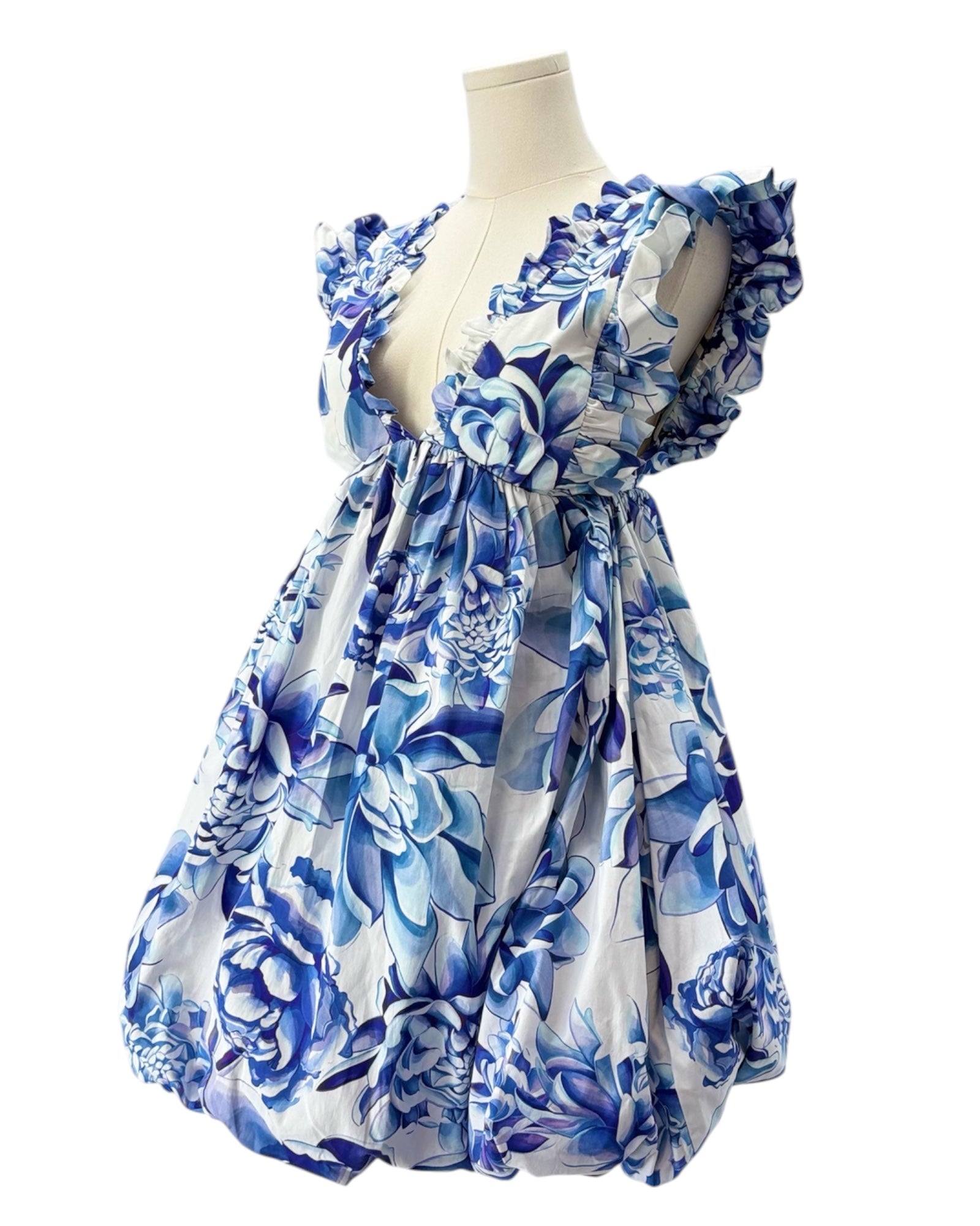 Blue floral dress on a mannequin against a white background