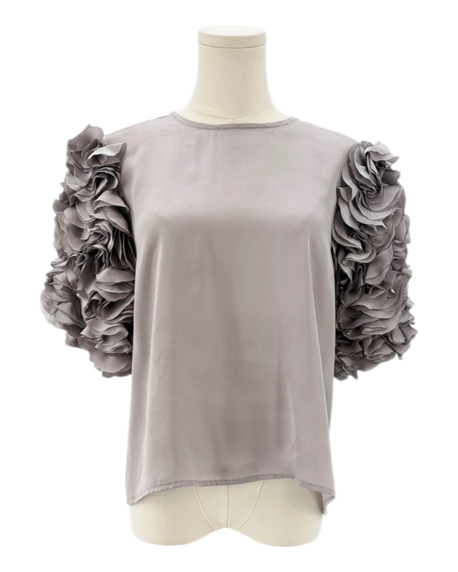 Gray top with floral sleeves on a mannequin against a white background