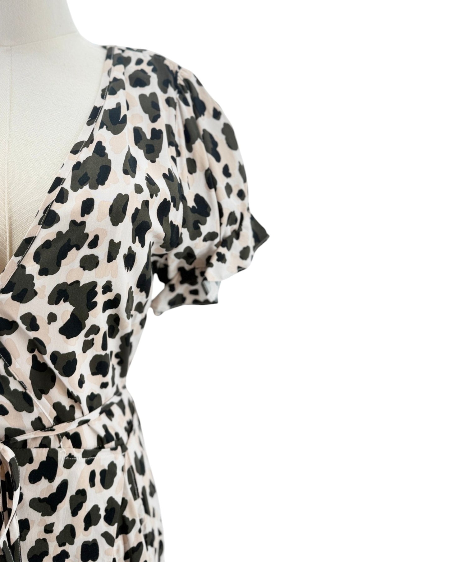 Mannequin wearing a leopard print dress on a white background