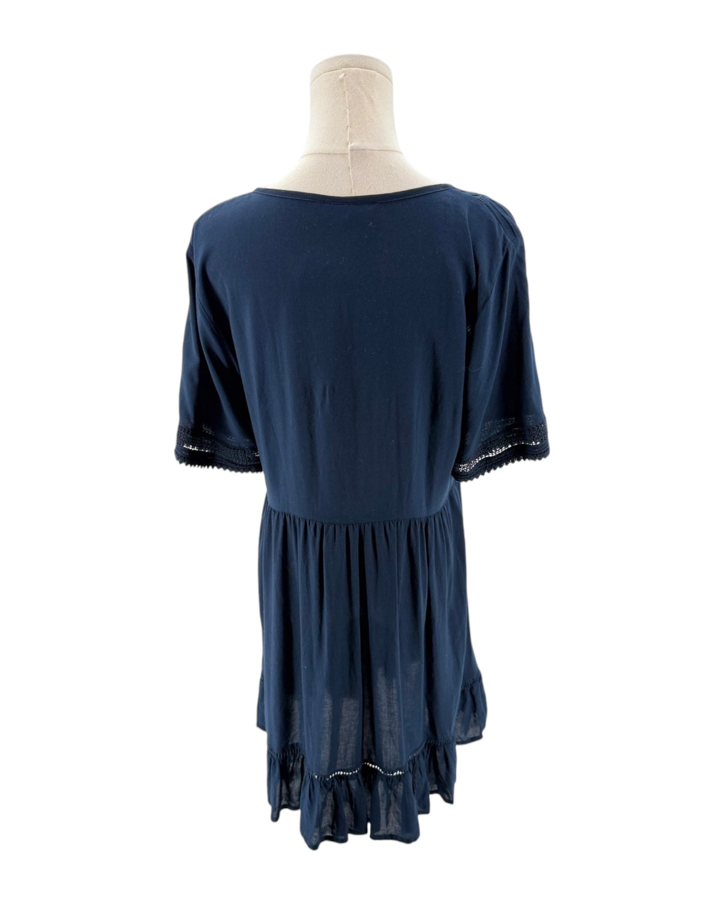Navy blue dress on a mannequin against a white background