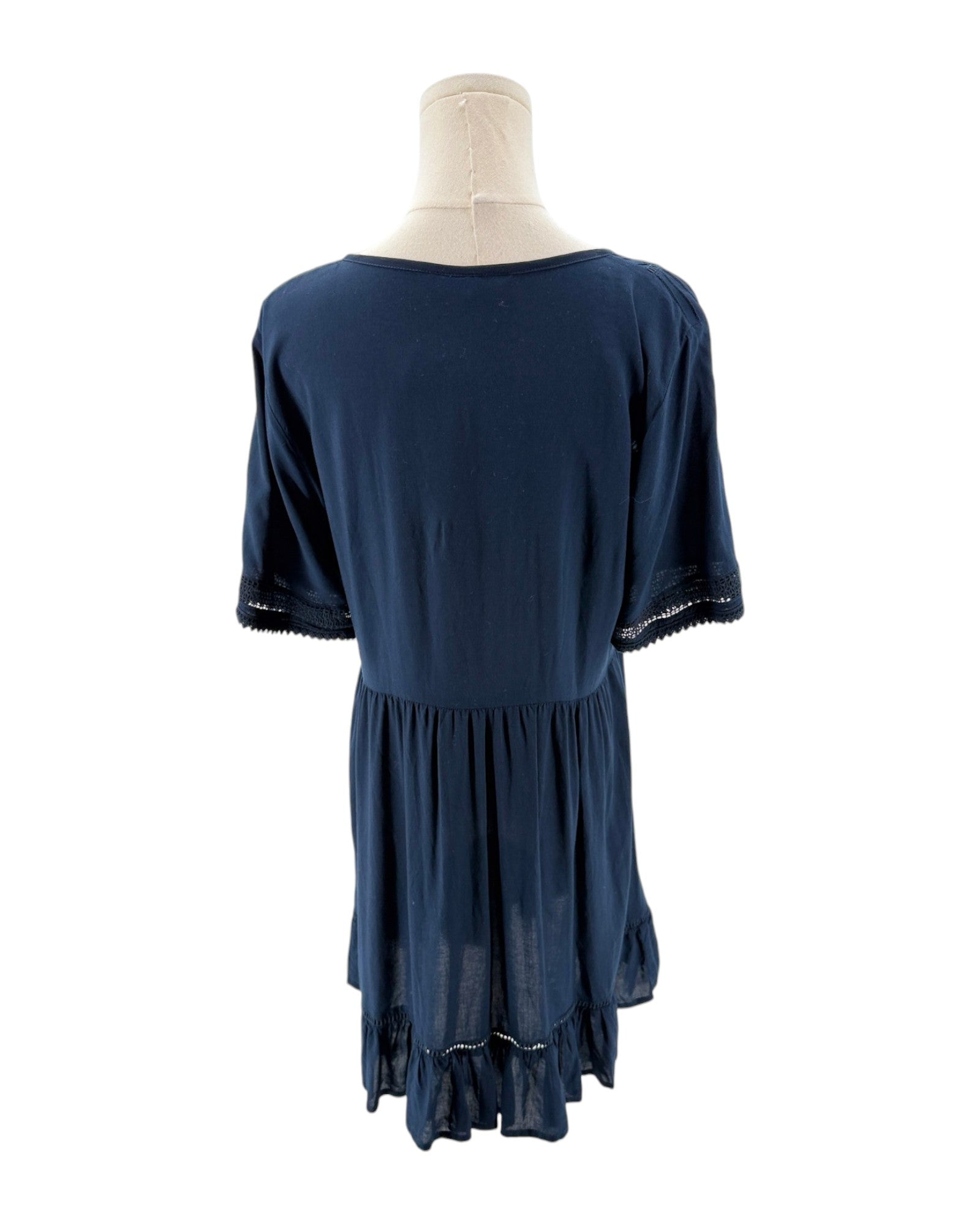 Navy blue dress on a mannequin against a white background