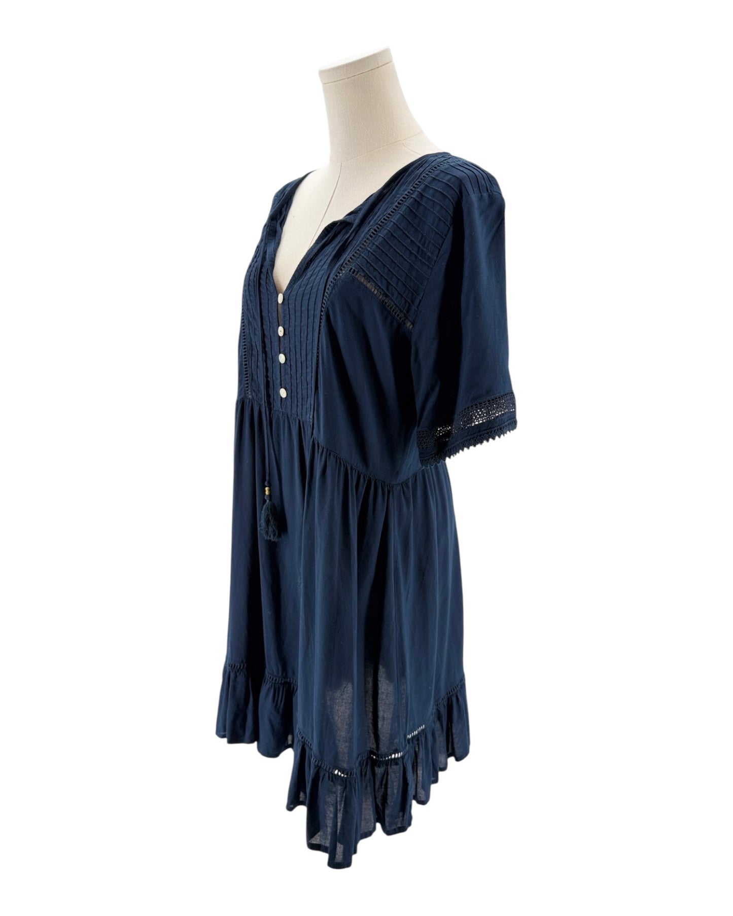 Navy blue dress on a mannequin against a white background