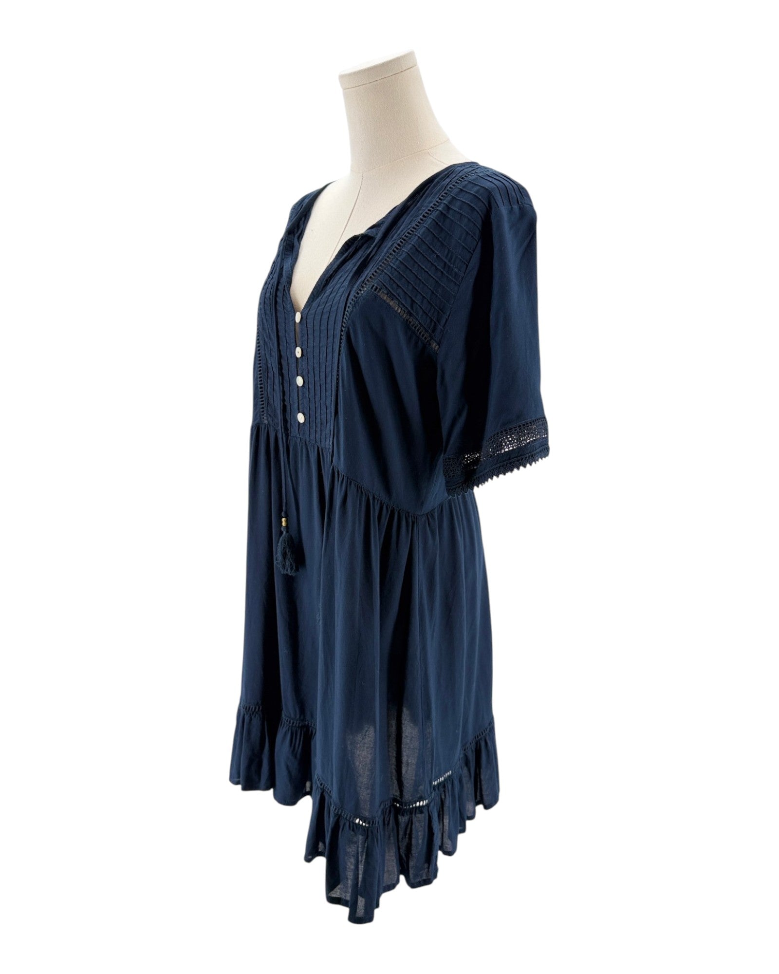 Navy blue dress on a mannequin against a white background