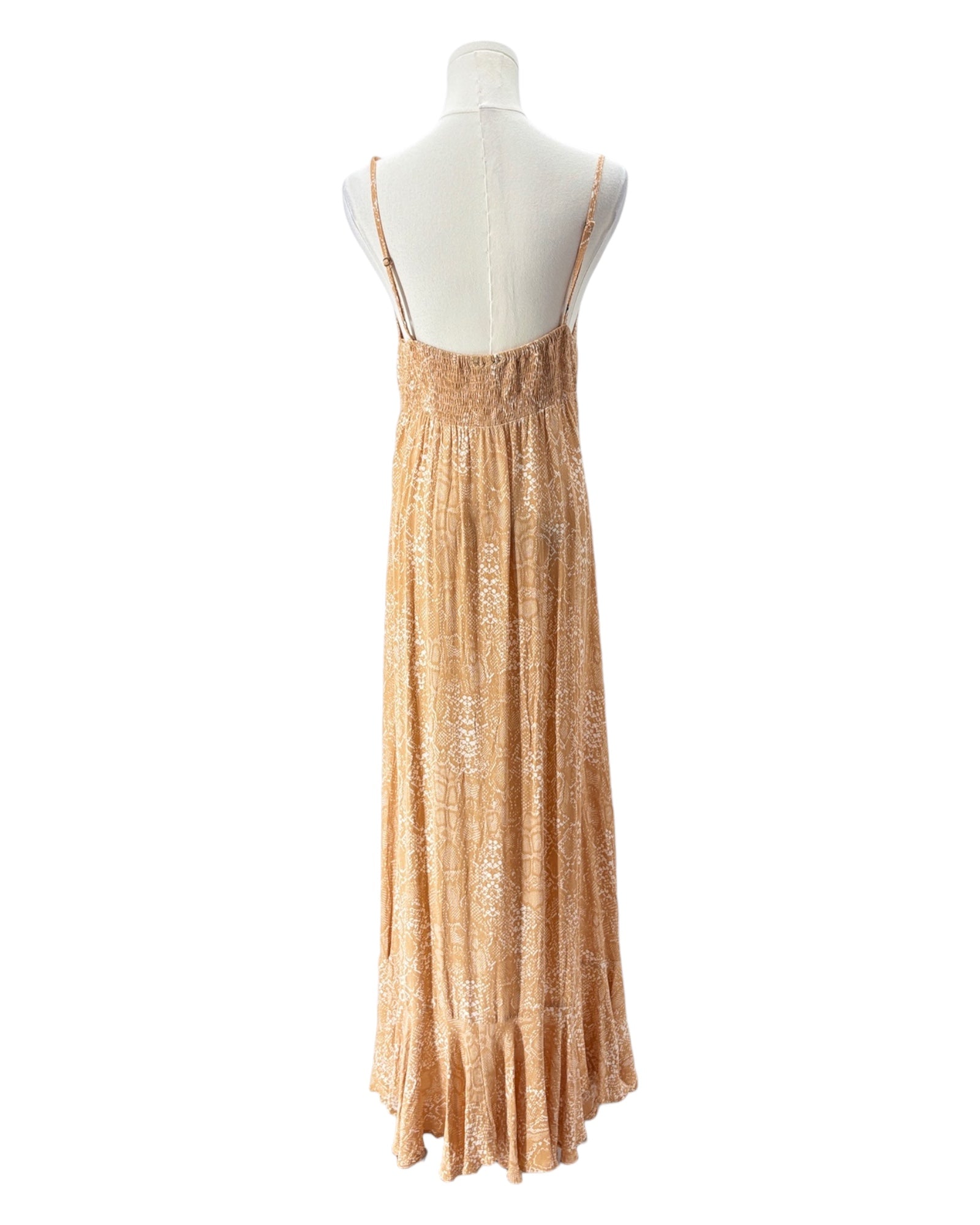 Mannequin wearing a long, light brown dress on a white background