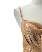 Brown lace top on a mannequin with a white background