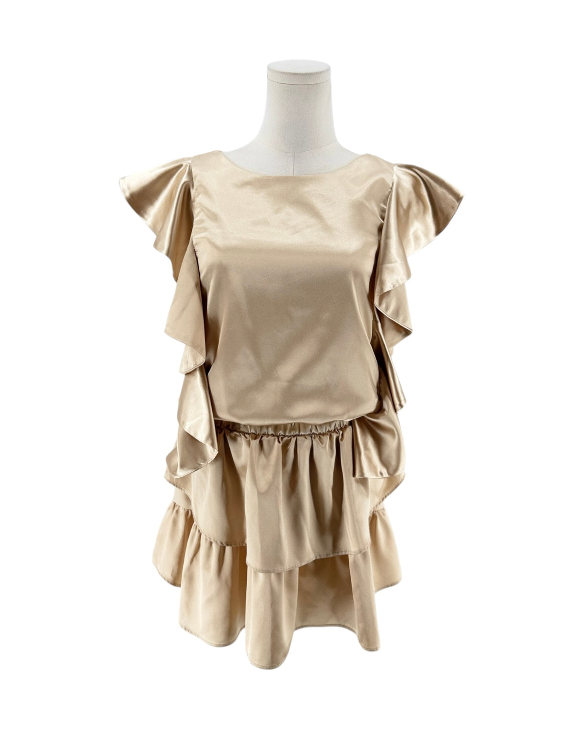 A beige satin-like top with layered ruffle details on the shoulders and waist, displayed on a mannequin torso against a plain white background.