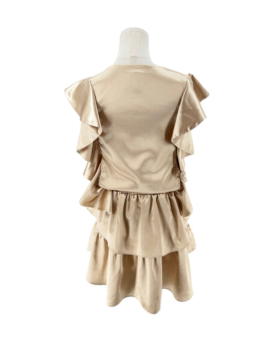 A beige satin-like dress displayed on a mannequin from the back, featuring layered ruffles and a tiered skirt against a plain white background.