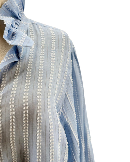 Close-up of a blue and white striped fabric with intricate patterns.