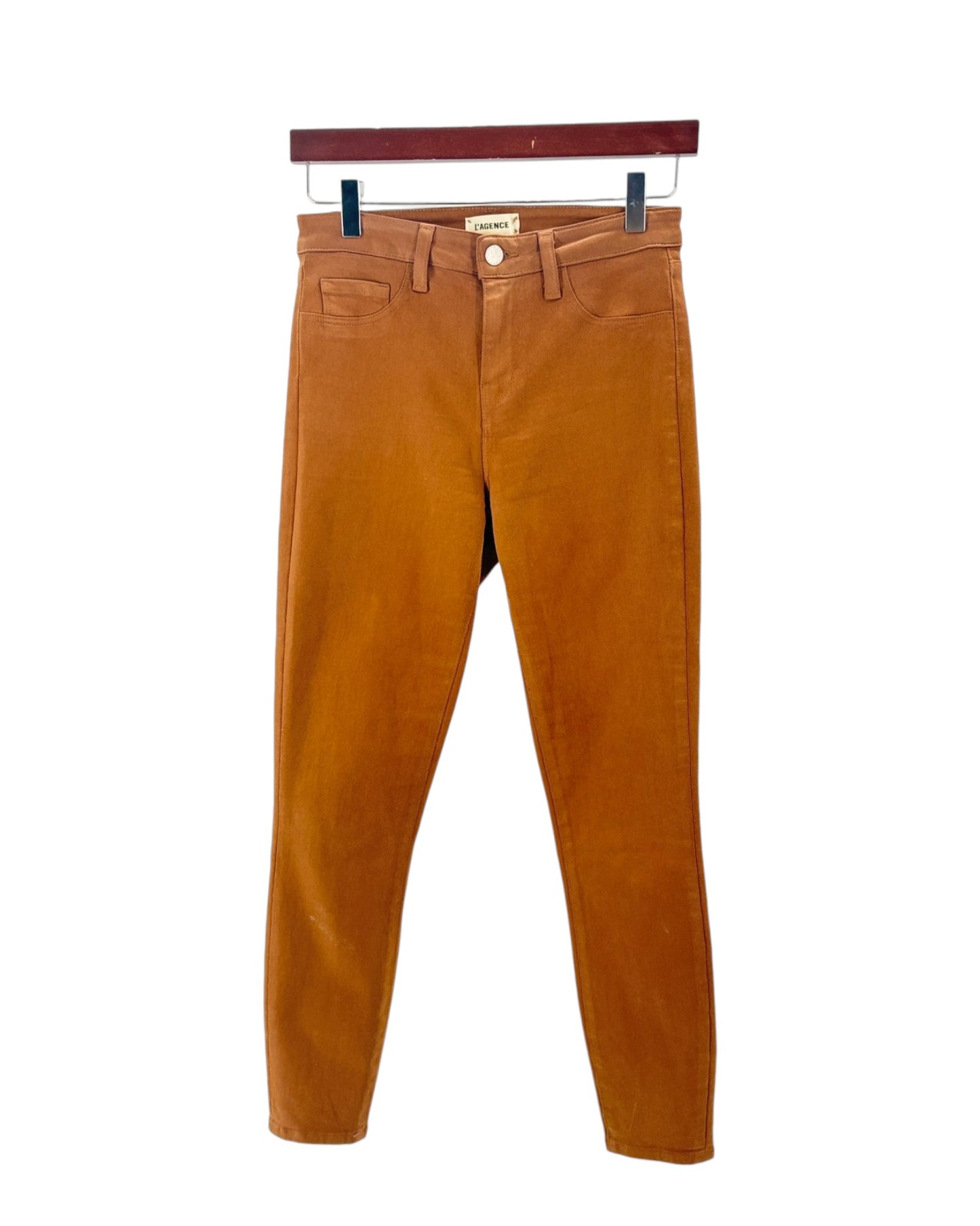 Brown pants on a hanger against a white background