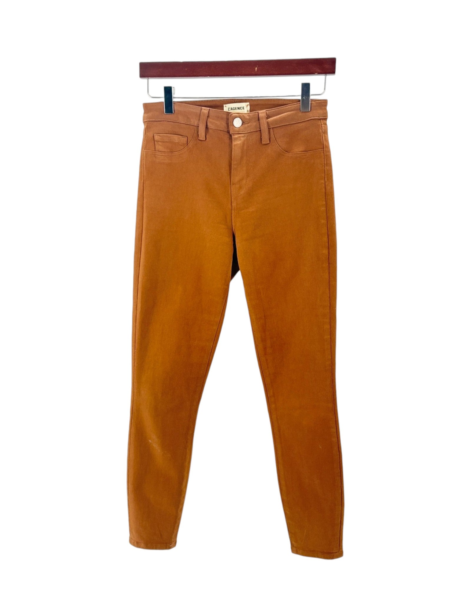 Brown pants on a hanger against a white background