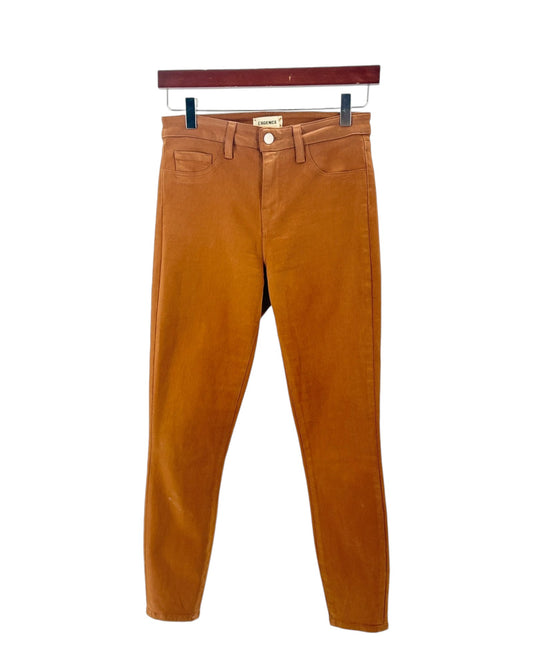Brown pants on a hanger against a white background