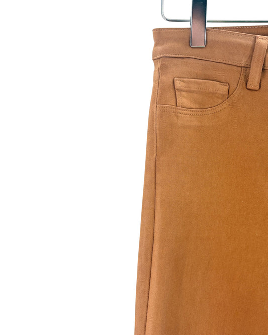 Brown pants on a hanger against a white background