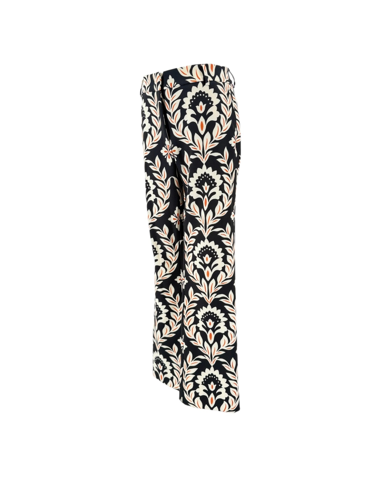 A pair of wide-leg trousers featuring a black base with a beige and white damask floral pattern, shown against a plain white background.