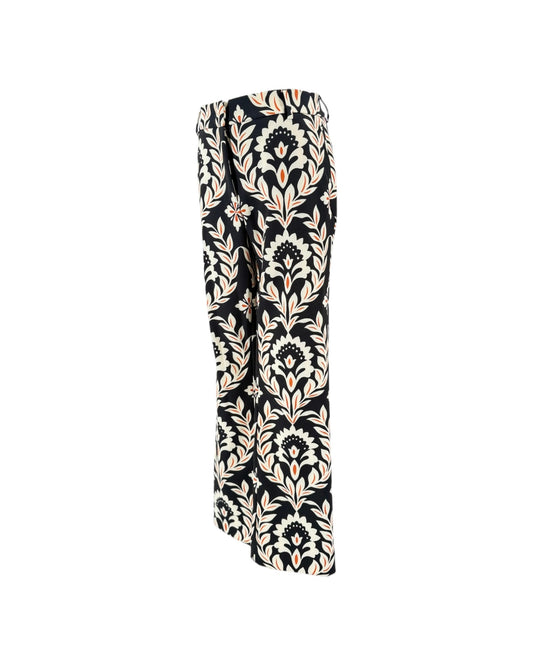 A pair of wide-leg trousers featuring a black base with a beige and white damask floral pattern, shown against a plain white background.