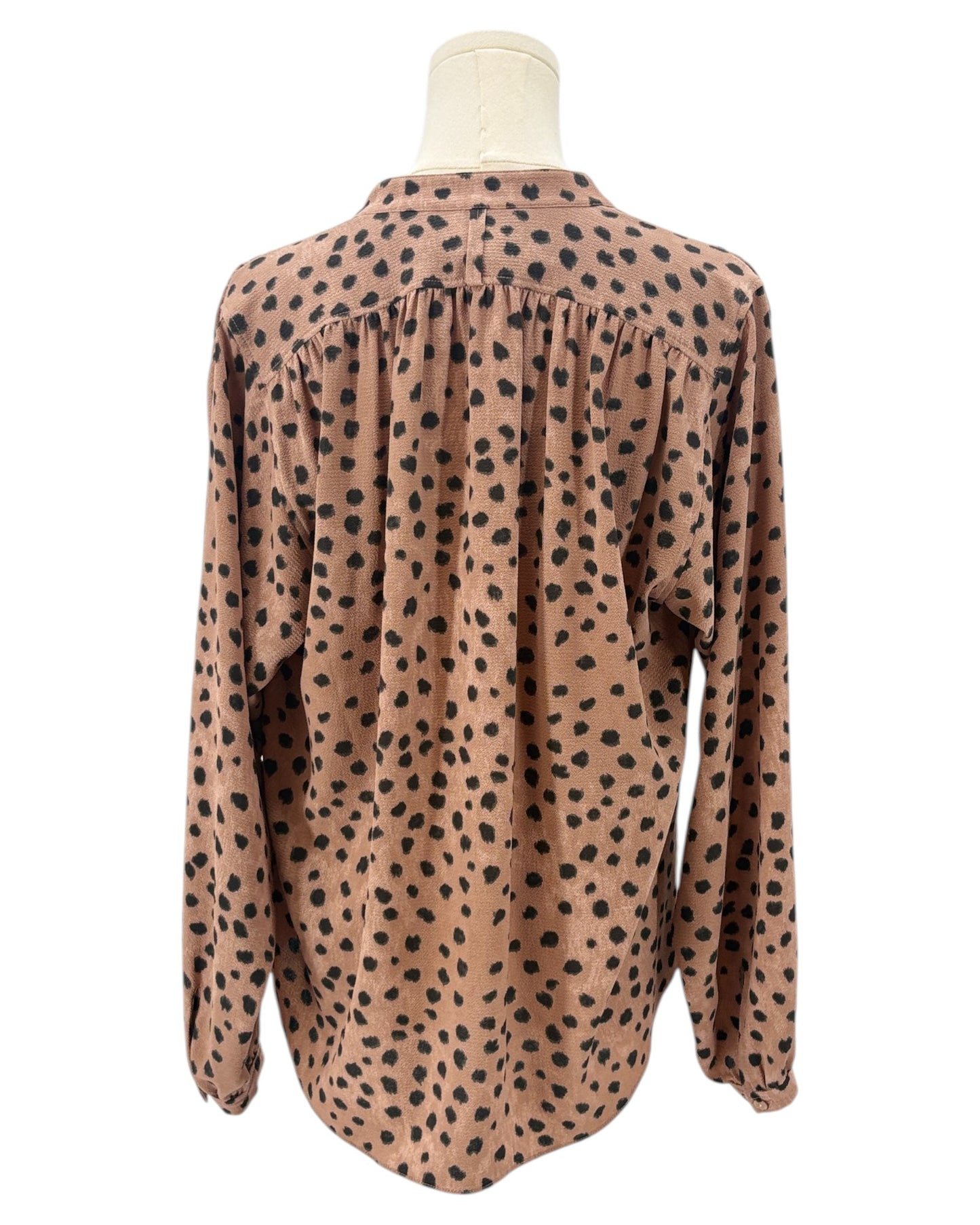 Brown shirt with black animal print pattern on a mannequin against a white background
