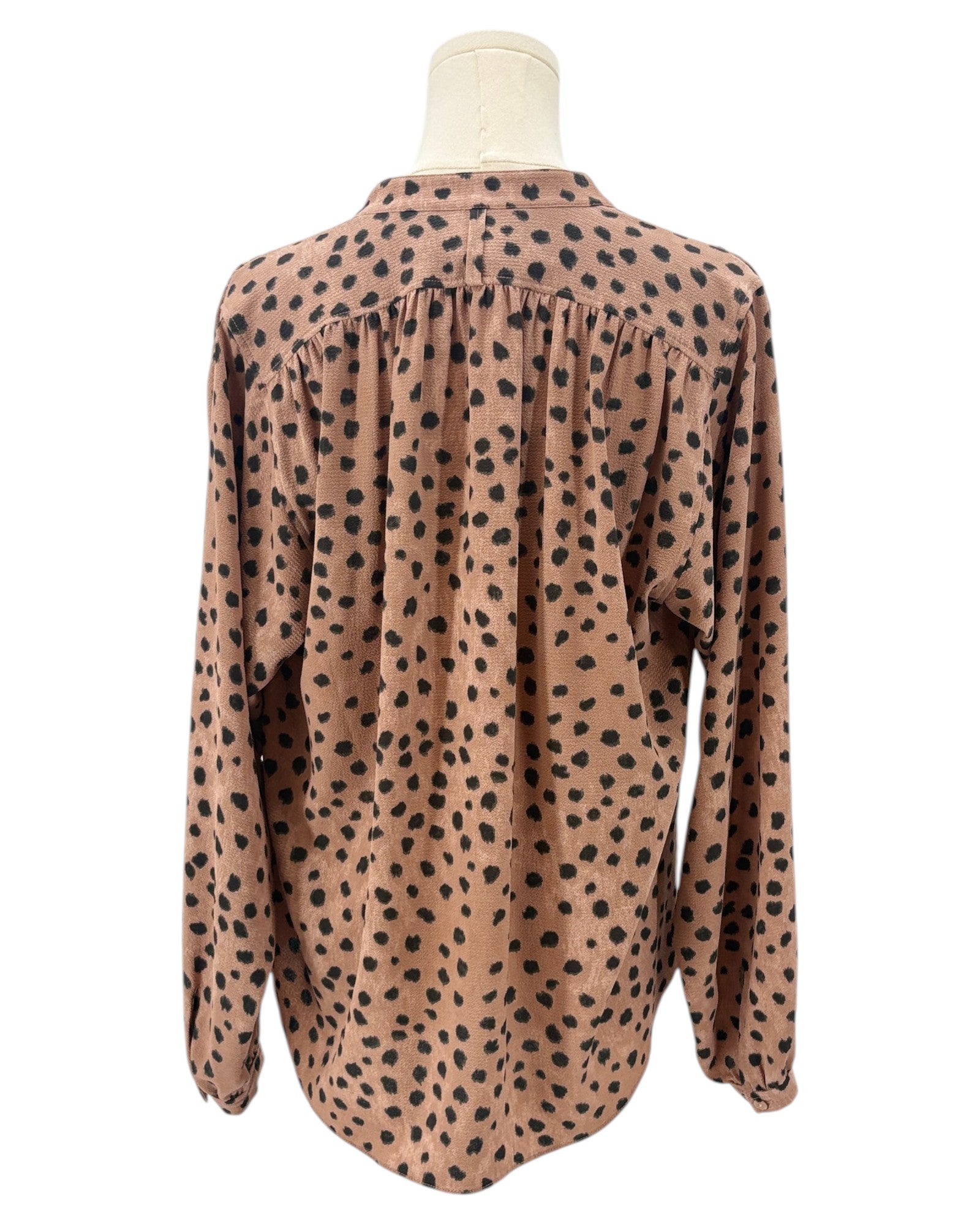 Brown shirt with black animal print pattern on a mannequin against a white background